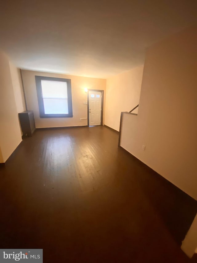 empty room with dark wood-type flooring