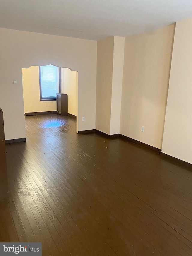 empty room with dark hardwood / wood-style floors