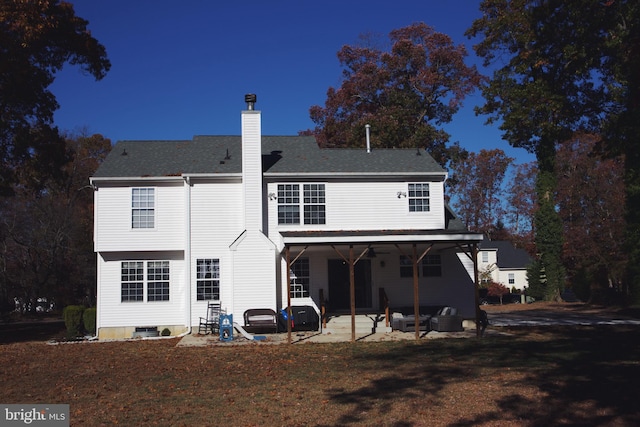 rear view of property featuring ceiling fan and a patio