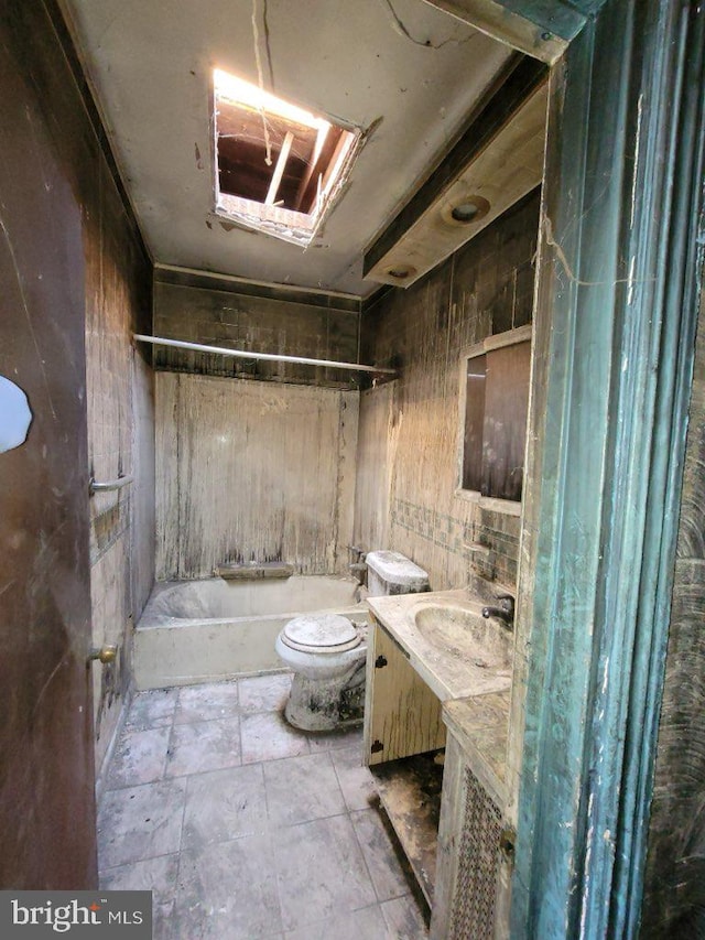 full bathroom with vanity, toilet, tile walls, and shower / washtub combination