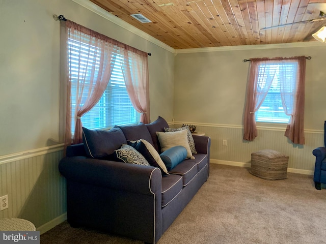 carpeted living room with crown molding and wood ceiling