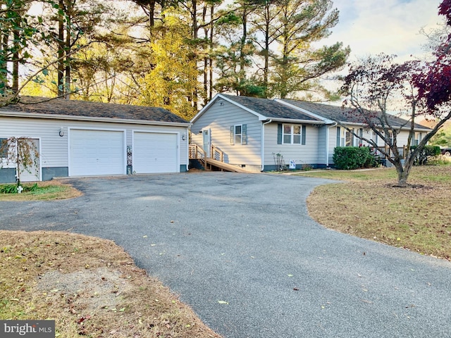 view of side of property featuring a detached garage and an outbuilding