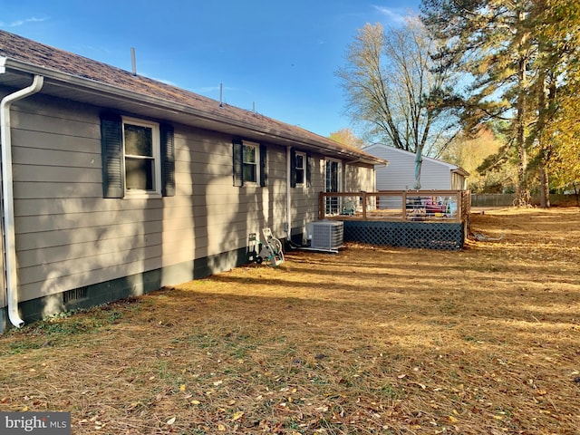 back of property featuring central air condition unit, a shingled roof, a yard, crawl space, and a wooden deck