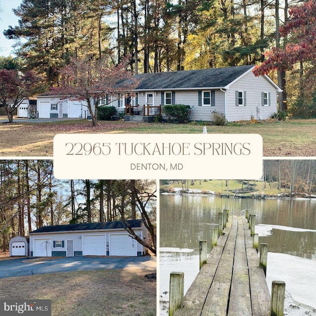 view of front of house with a boat dock, a detached garage, and a water view