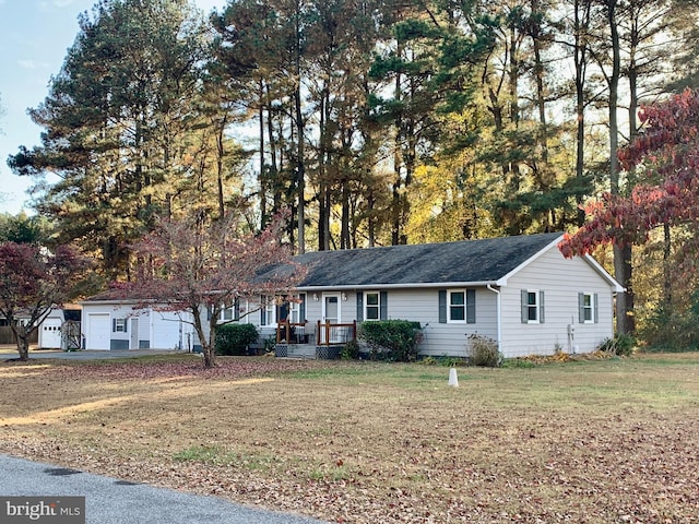 ranch-style home featuring a front yard and a garage