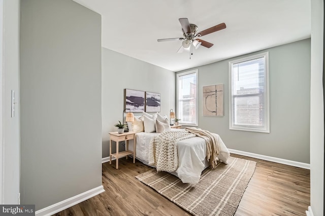 bedroom with wood-type flooring and ceiling fan