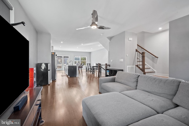 living room with hardwood / wood-style floors and ceiling fan