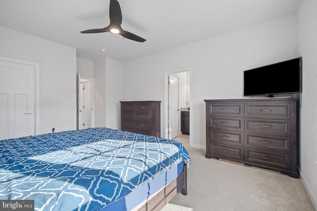 bedroom featuring ensuite bathroom, ceiling fan, and light carpet