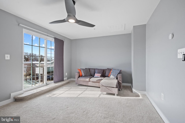 living room with ceiling fan and light colored carpet