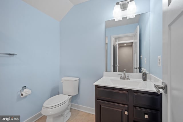 bathroom featuring toilet, vanity, tile patterned floors, and lofted ceiling