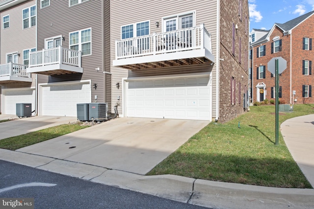 view of property with central AC and a garage