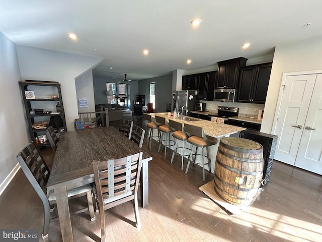 dining area with sink and dark wood-type flooring