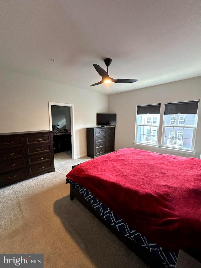 bedroom with ceiling fan and light colored carpet