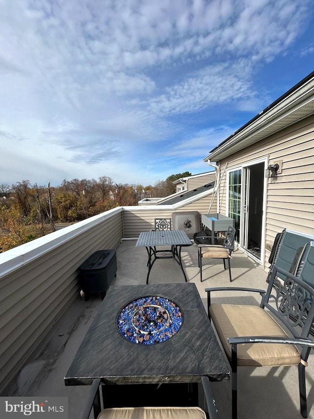 view of patio featuring a balcony