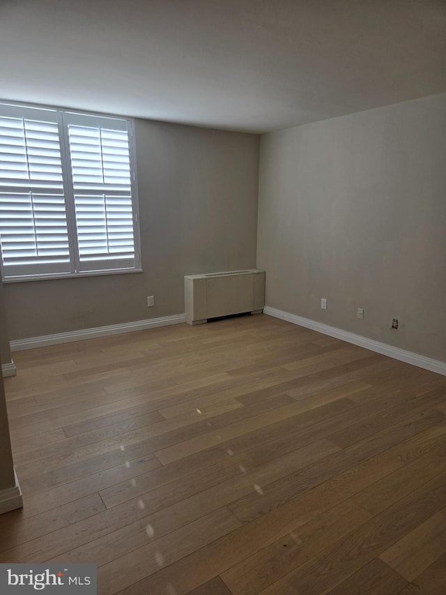 unfurnished room with hardwood / wood-style flooring