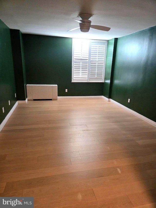 spare room featuring light wood-type flooring and ceiling fan