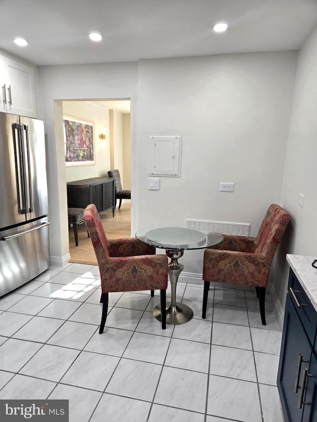 dining space featuring light tile patterned floors