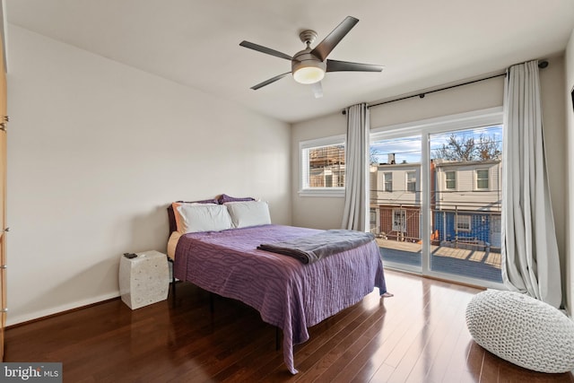 bedroom with access to outside, dark hardwood / wood-style floors, and ceiling fan