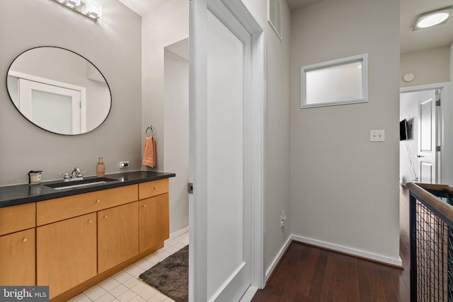 bathroom with vanity and hardwood / wood-style flooring