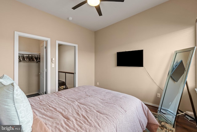 bedroom featuring ceiling fan, dark hardwood / wood-style floors, a spacious closet, and a closet