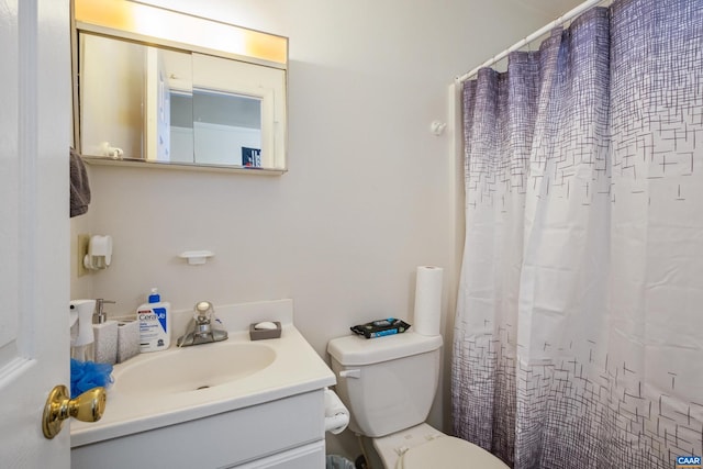 bathroom featuring toilet, a shower with curtain, and vanity