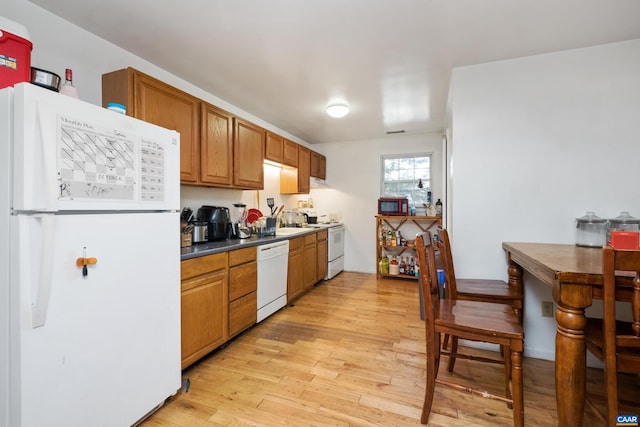 kitchen with white appliances and light wood-type flooring