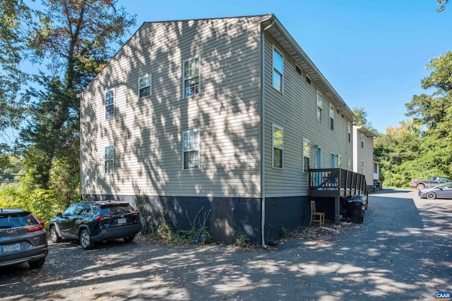 view of property exterior featuring a wooden deck