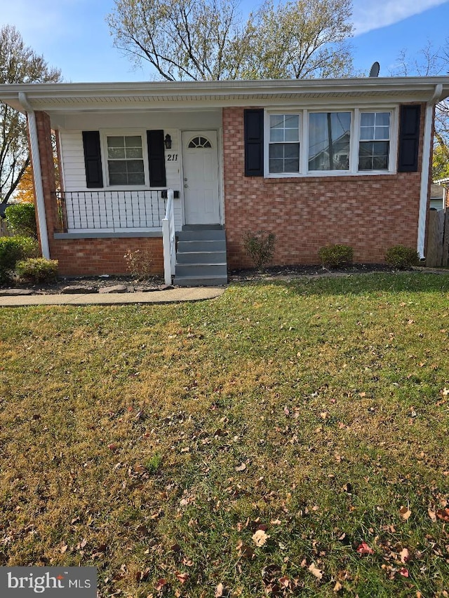 ranch-style house featuring a front lawn and covered porch