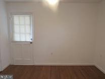 unfurnished room featuring dark hardwood / wood-style flooring