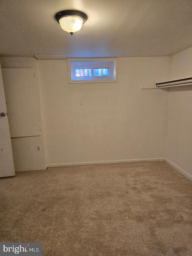 basement featuring a textured ceiling and carpet floors