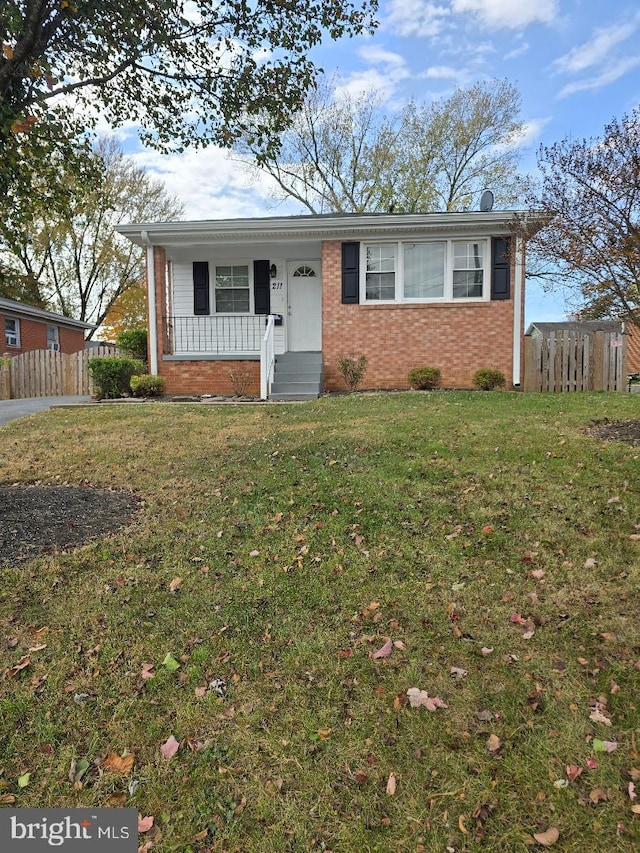 single story home featuring covered porch and a front lawn