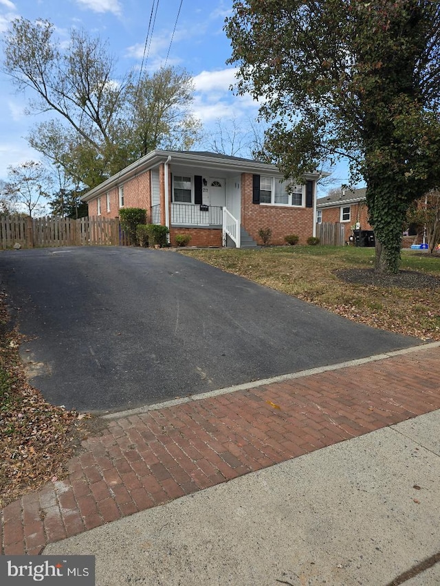 single story home featuring covered porch