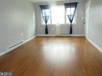 spare room featuring wood-type flooring