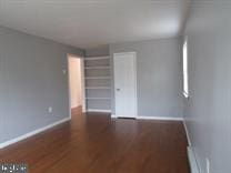 empty room featuring dark wood-type flooring