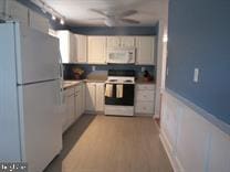 kitchen with white appliances, ceiling fan, and light wood-type flooring