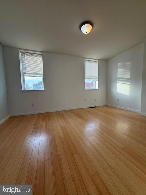 spare room featuring a wealth of natural light and light wood-type flooring