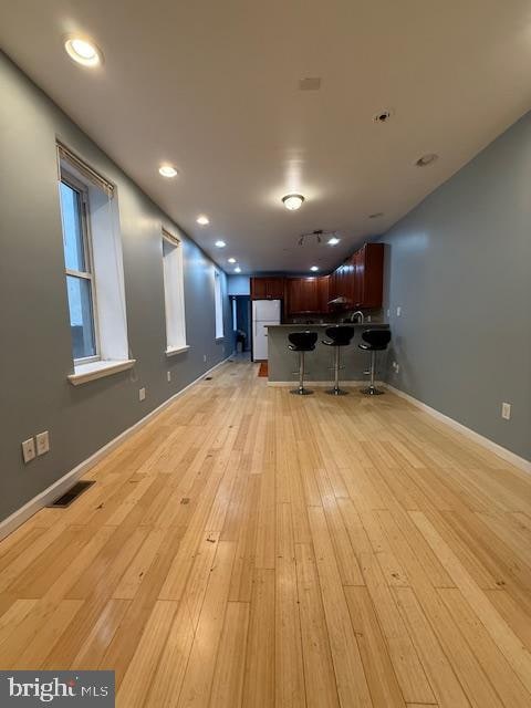 unfurnished living room featuring light wood-type flooring