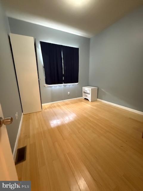 spare room with light wood-type flooring