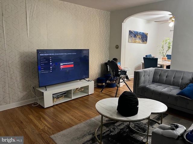 living room featuring ceiling fan and wood-type flooring