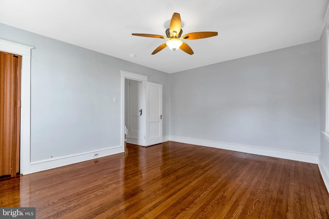 empty room featuring ceiling fan and dark wood-type flooring