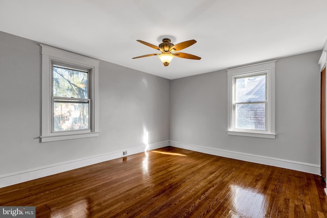 unfurnished room with ceiling fan, plenty of natural light, and hardwood / wood-style floors