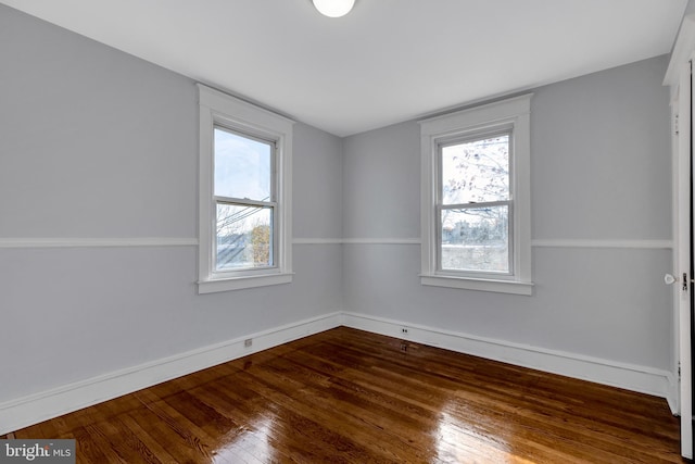 unfurnished room with hardwood / wood-style flooring