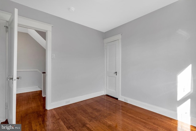 empty room with hardwood / wood-style flooring