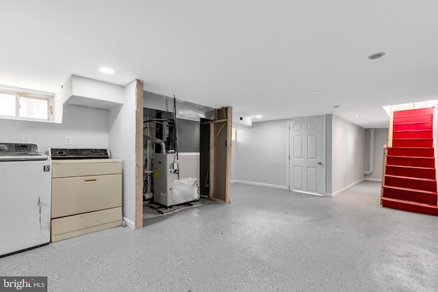 basement with washing machine and clothes dryer and heating unit