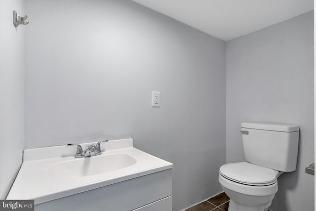 bathroom featuring toilet, vanity, and tile patterned floors