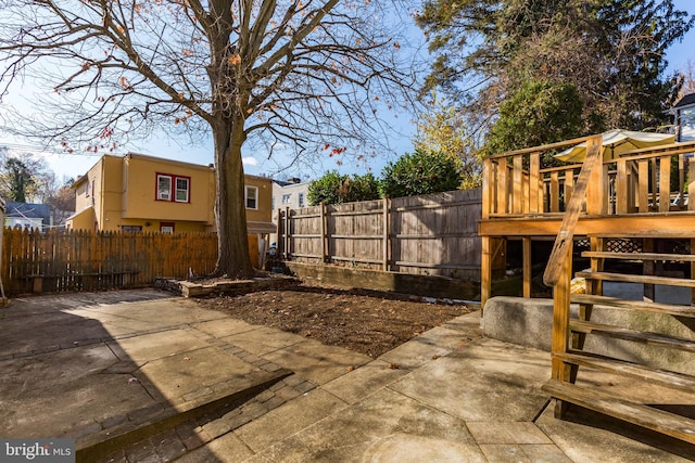 view of yard featuring a patio and a wooden deck