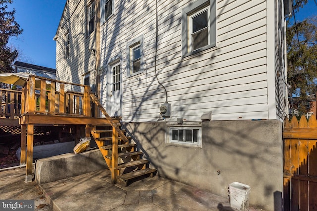 view of home's exterior with a patio area and a deck