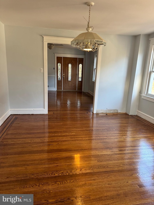 interior space featuring dark hardwood / wood-style flooring and an inviting chandelier