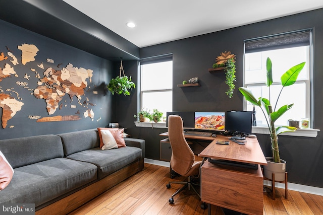 home office with light hardwood / wood-style floors