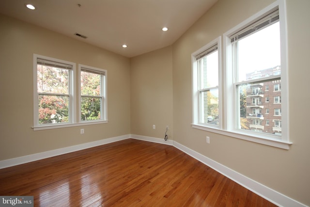 unfurnished room featuring hardwood / wood-style flooring